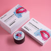 Een Diamond Smile tandbleekset, witmakende gel en witmakende actieve kool met een roze achtergrond